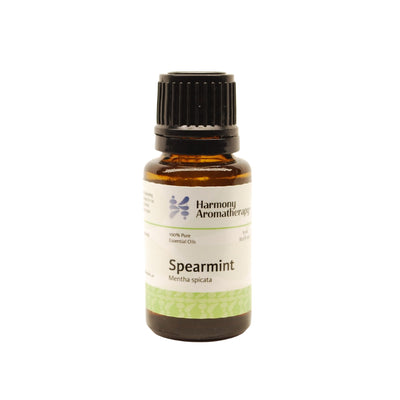 Spearmint essential oil on white background