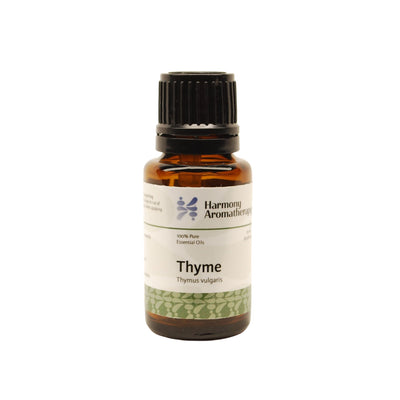 Thyme essential oil on white background
